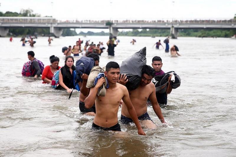migrant caravan river