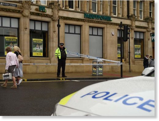 A police officer stands on duty by a police cordon
