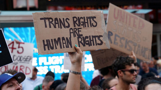Click to enlarge trans activists sign protest