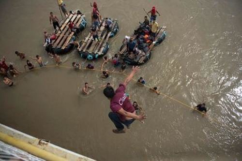 Click to enlarge migrants in water