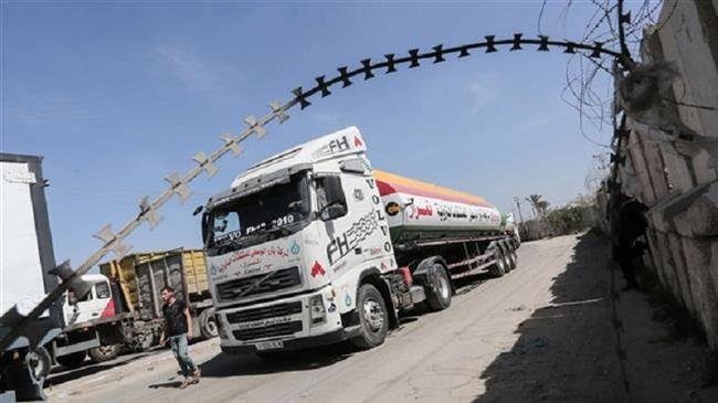 Palestinian truck drivers park their lorries near the Kerem Shalom crossing between the southern Gaza Strip