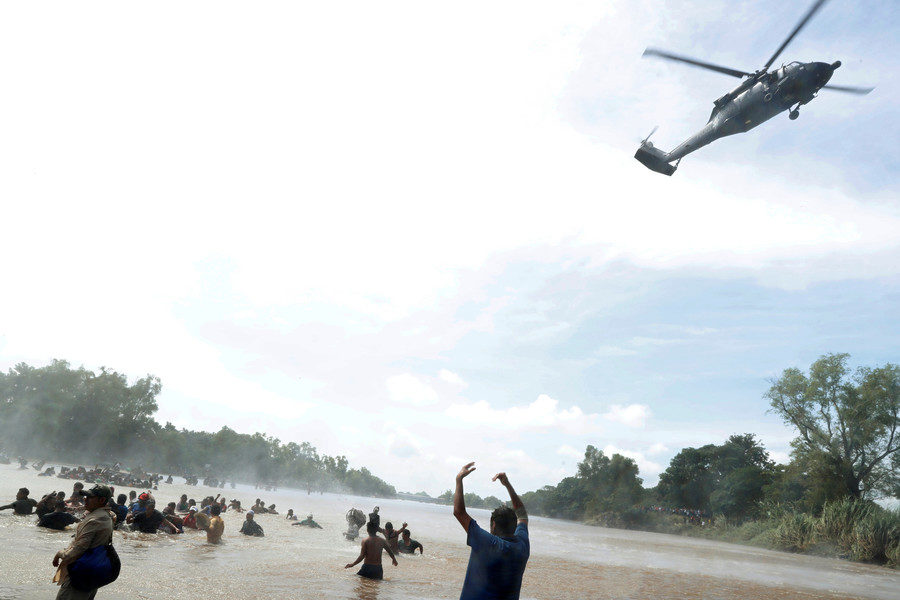 Click to enlarge A Mexican police helicopter migrants