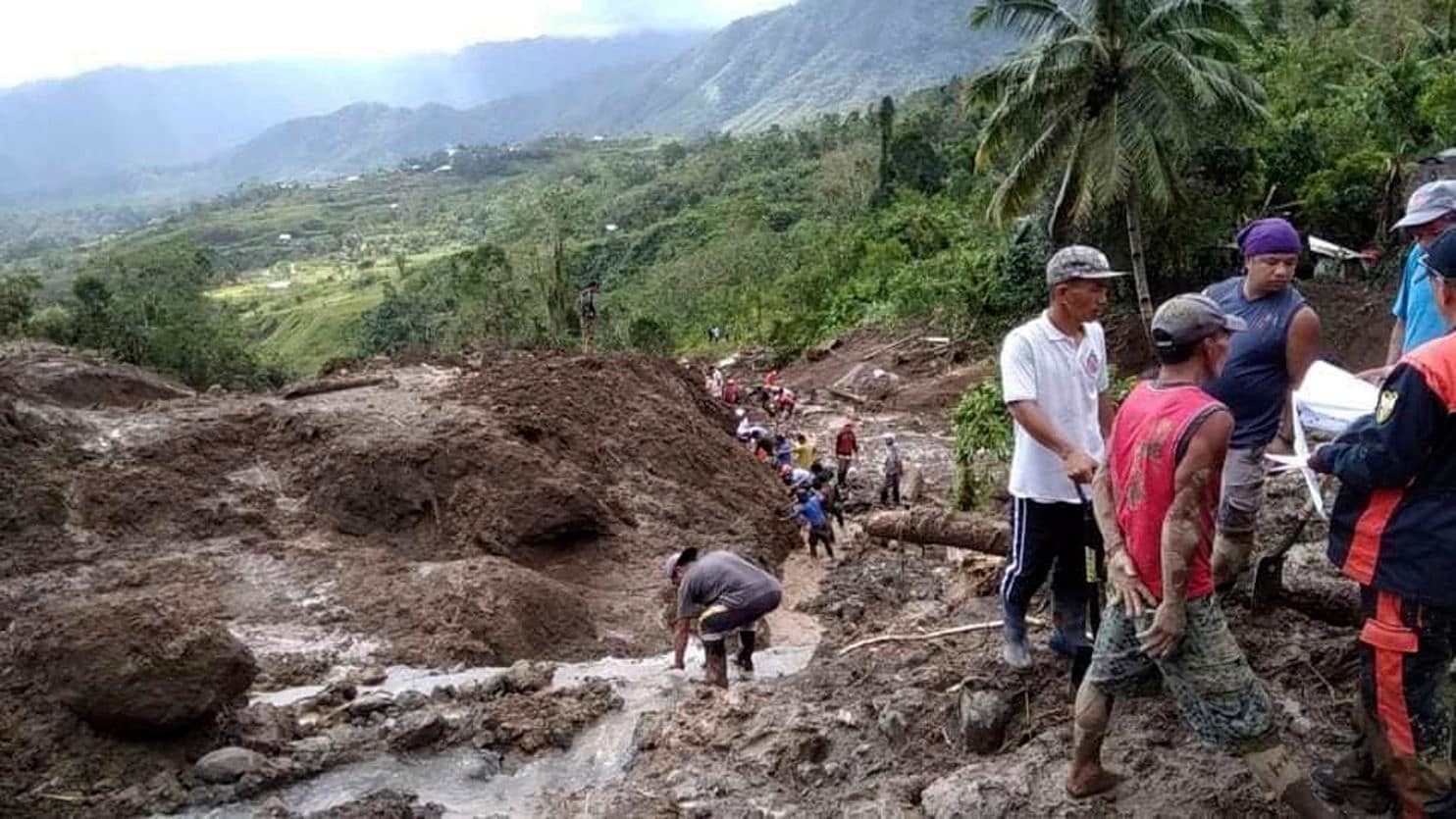 rescuers dig through the earth to search for survivors after a massive landslide in Natonin ...