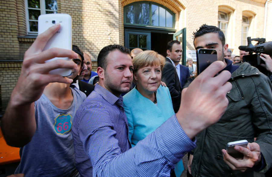 Merkel takes a selfie with a refugee