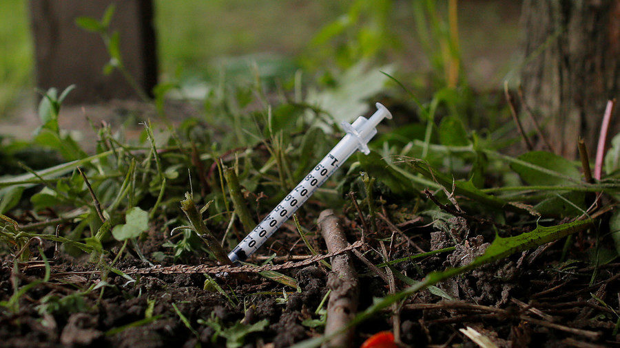 Click to enlarge syringe in dirt