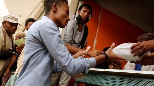 Click to enlarge man receives food ration Yemen
