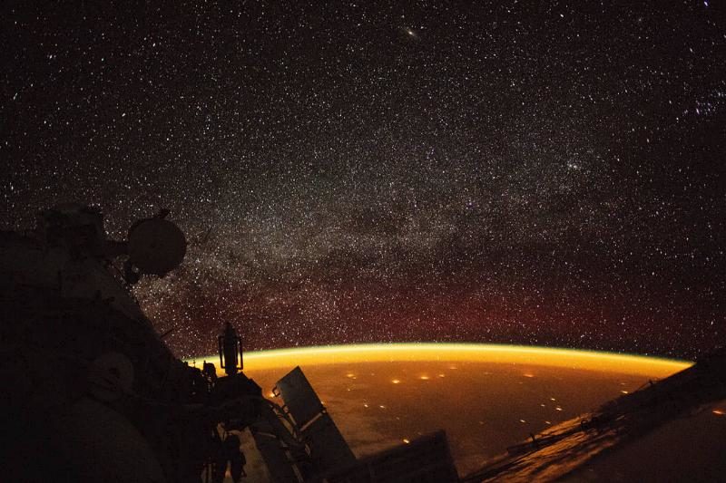 Click to enlarge airglow enveloping Earth