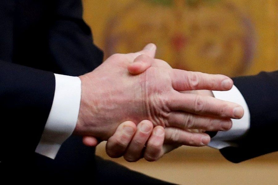 Click to enlarge Emmanuel Macron shakes Donald Trump‘s hand as they meet on Staurday.