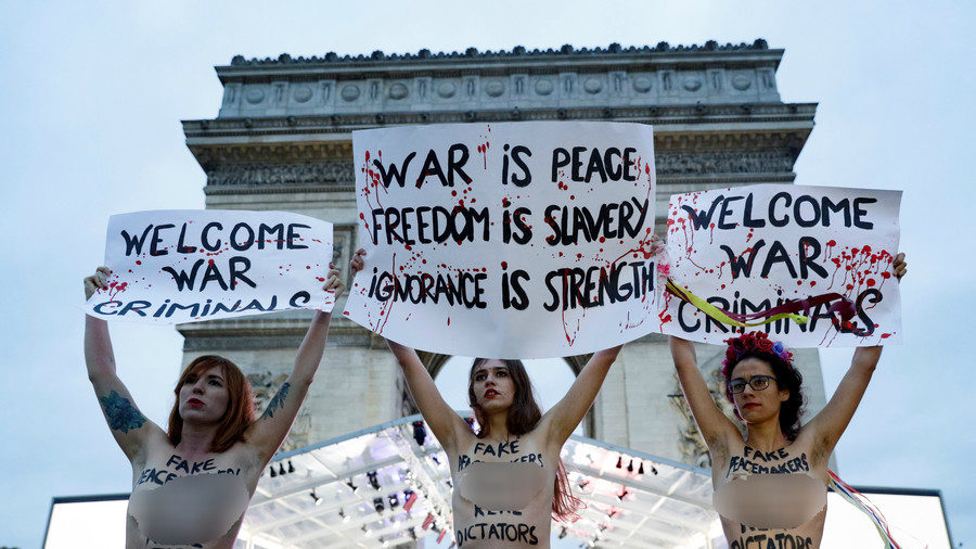 FEMEN activists pose for media at the Arc de Triomphe