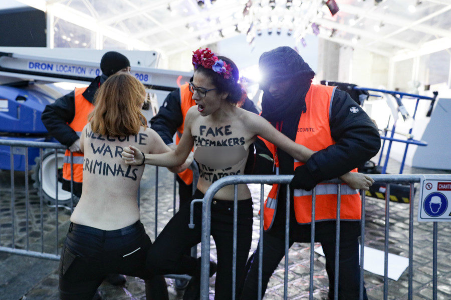 Click to enlarge The activists scuffle with security