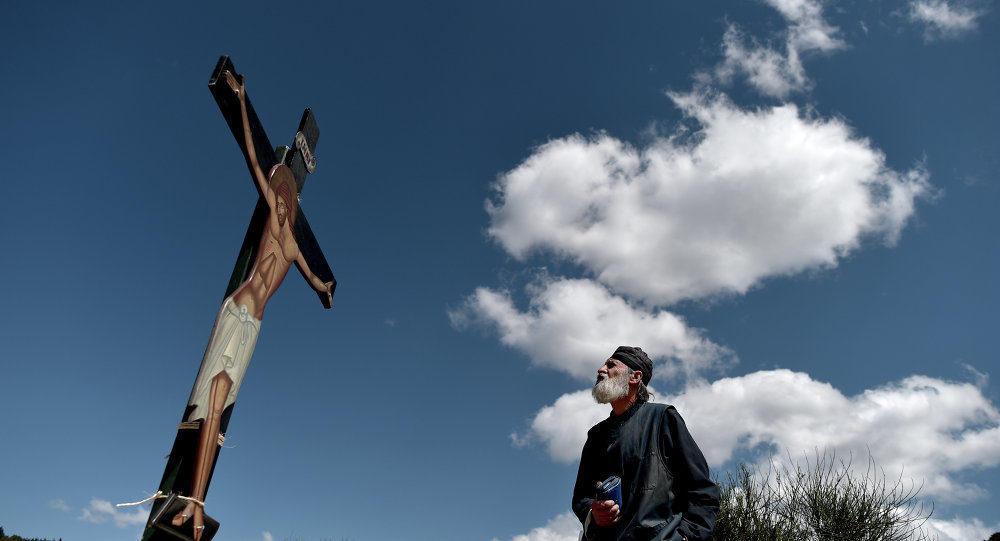 Click to enlarge priest looking at jesus on cross