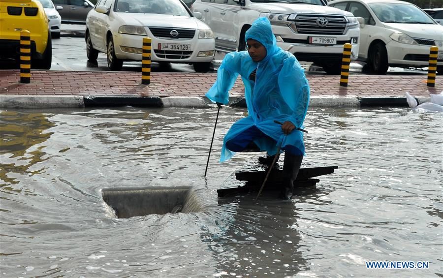 A municipal worker lifts the manhole