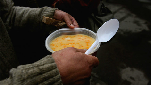 Homeless person with soup