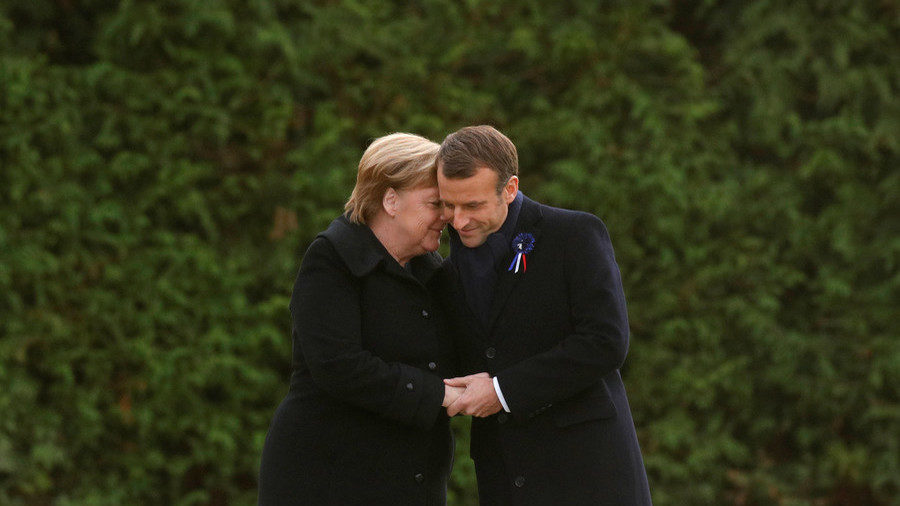 French President Emmanuel Macron and German Chancellor Angela Merkel hold hands in Compiegne France on November 10 2018