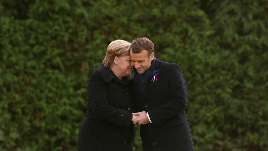 Click to enlarge French President Emmanuel Macron and German Chancellor Angela Merkel hold hands in Compiegne France on November 10 2018