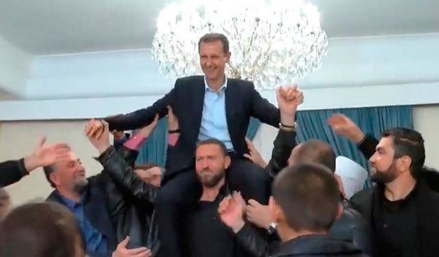 Assad shoulders celebrate