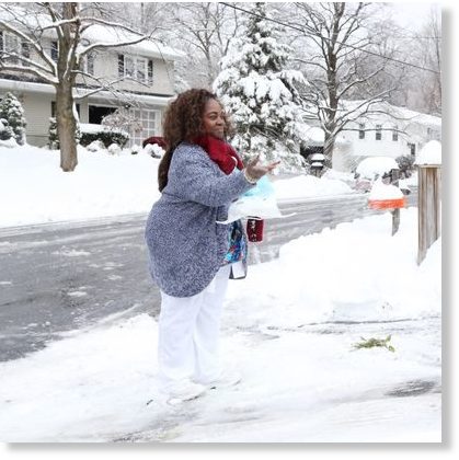 Faye Latouche spreads rock salt on her steep driveway in theTown of Poughkeepsie on November 16