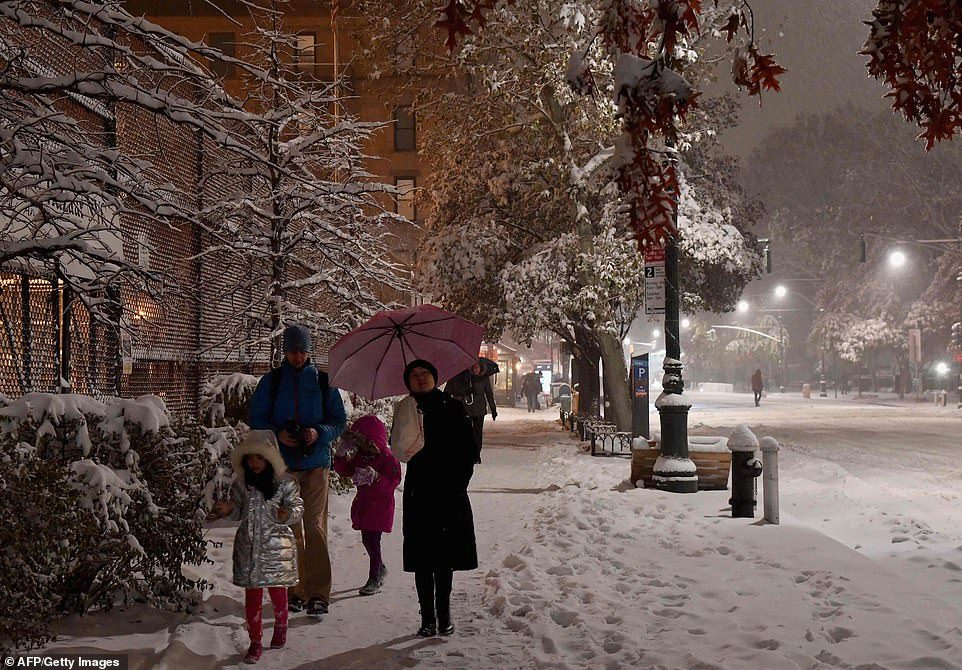 Click to enlarge Pedestrians walk through snow and ice in Manhattan on November 15, 2018 in New York