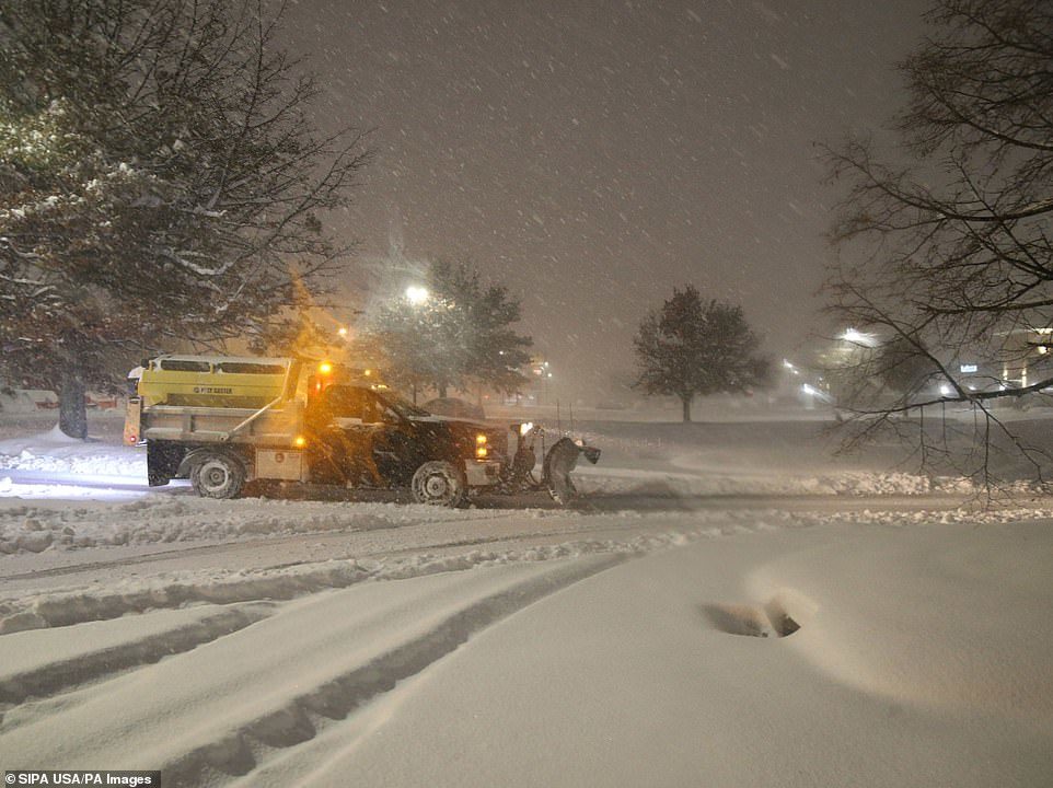 A plow clears a parking lot at the Hudson Valley Towne Center parking lot in Fishkill