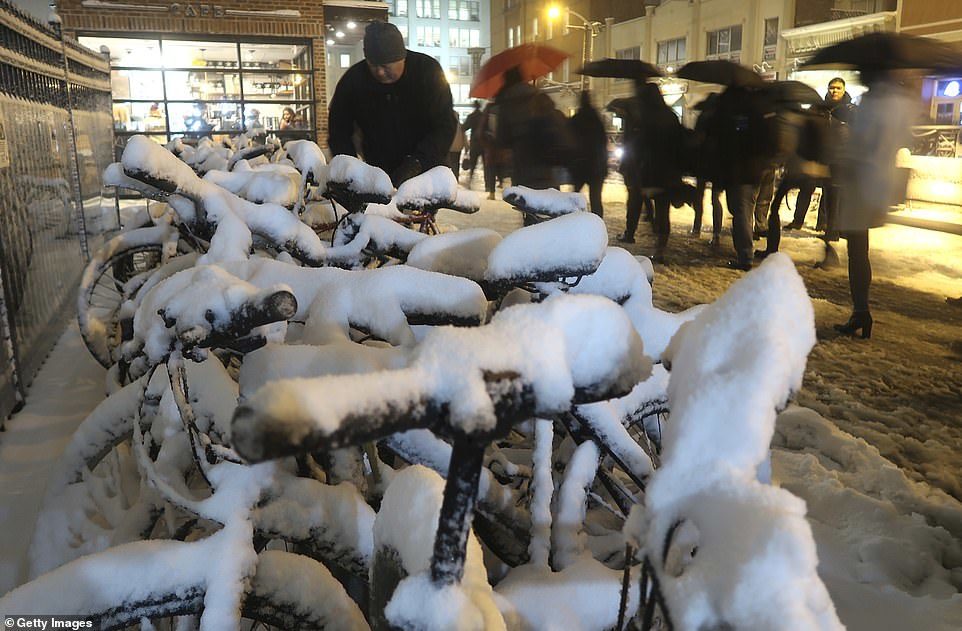 Snow piles up on bicycles outside the transit terminal in Hoboken, New Jersey, after a snowstorm on Thursday