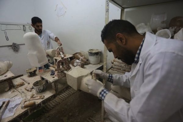 Click to enlarge Technicians prepare prostheses
