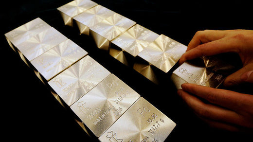 An employee places ingots of 99.98 percent pure palladium on a table