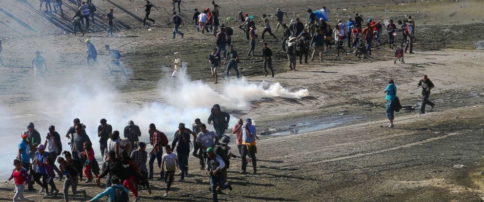 Migrants tear gas