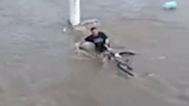 Horrific moment cyclist is swept to death by flash flood in Brazil