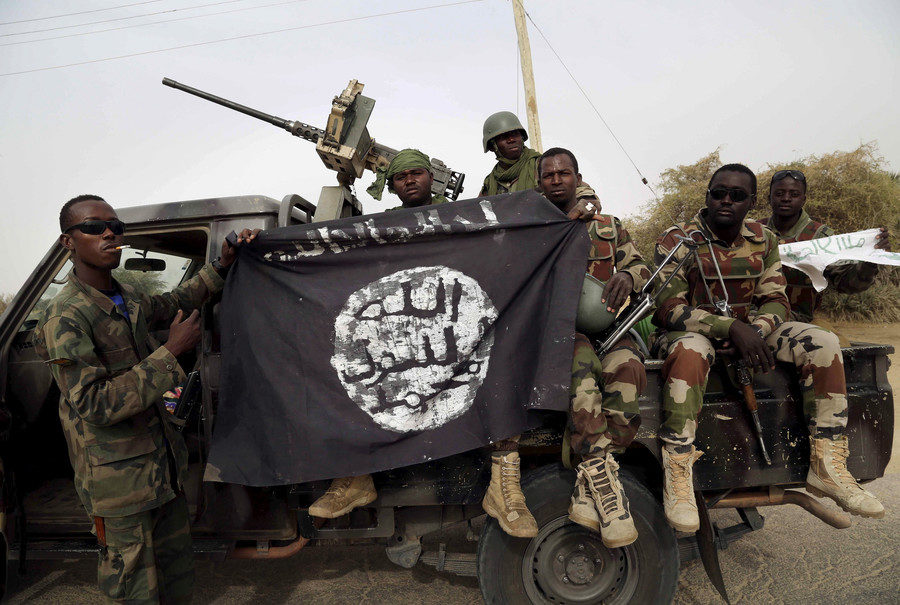 Click to enlarge Nigerian soldiers with captured Boko Haram flag