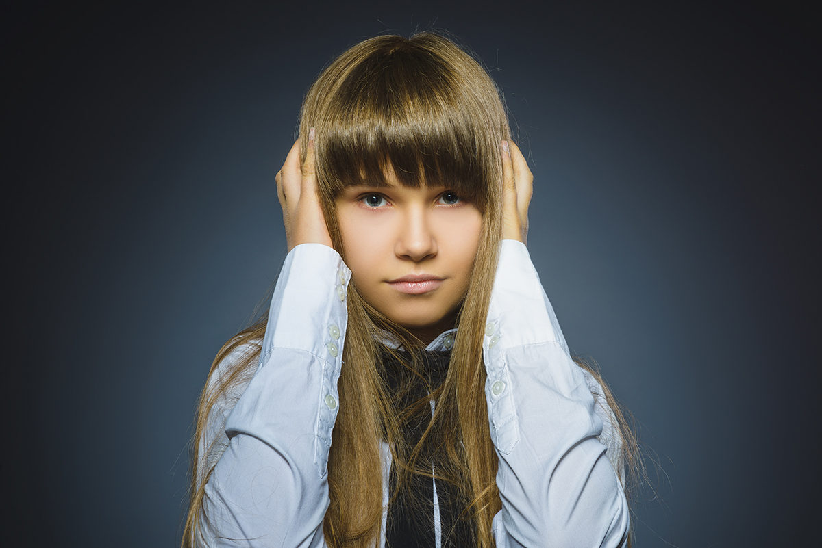 Click to enlarge girl covering ears