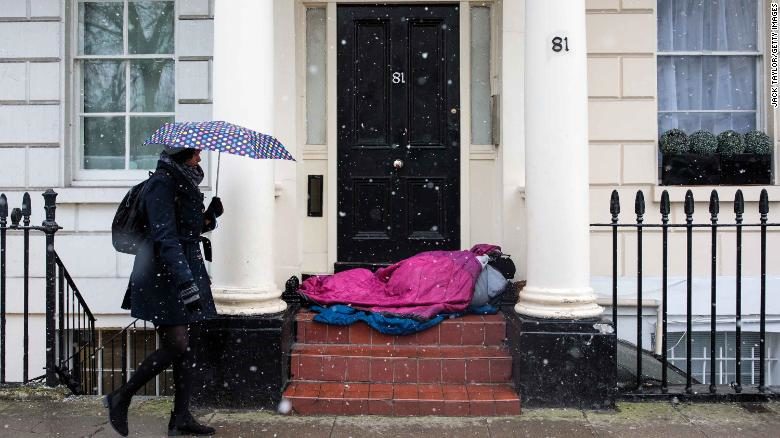 Homeless person sleeping in a doorway