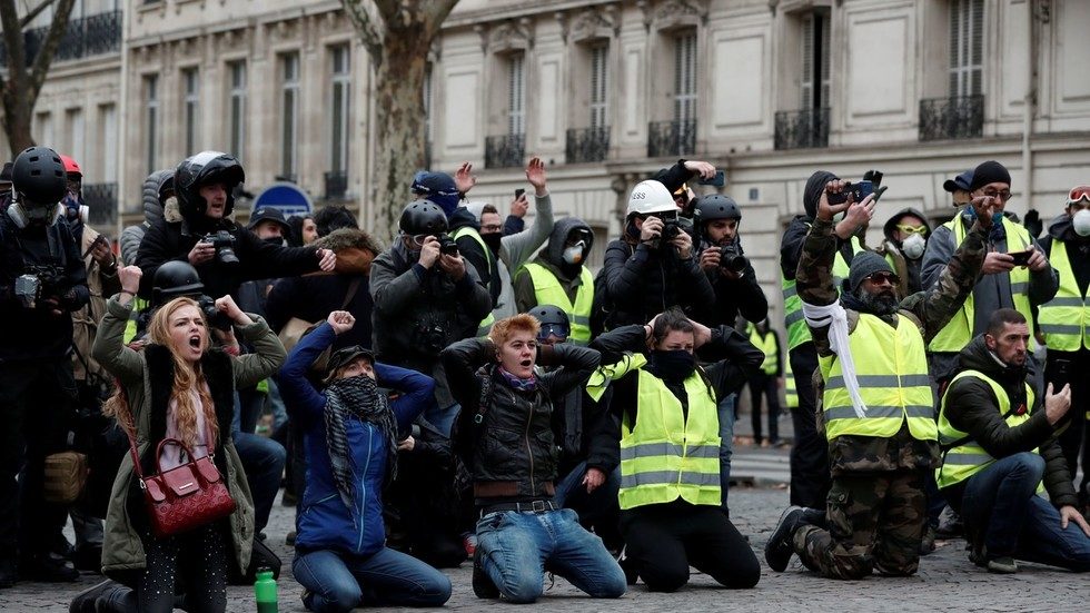 Protesters kneel