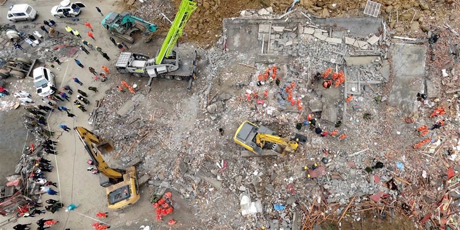 Rescuers search for survivors at the accident site after a landslide killed four, in Fenshui Town, Xuyong County, Luzhou City, southwest China's Sichuan Province, on December 10, 2018.