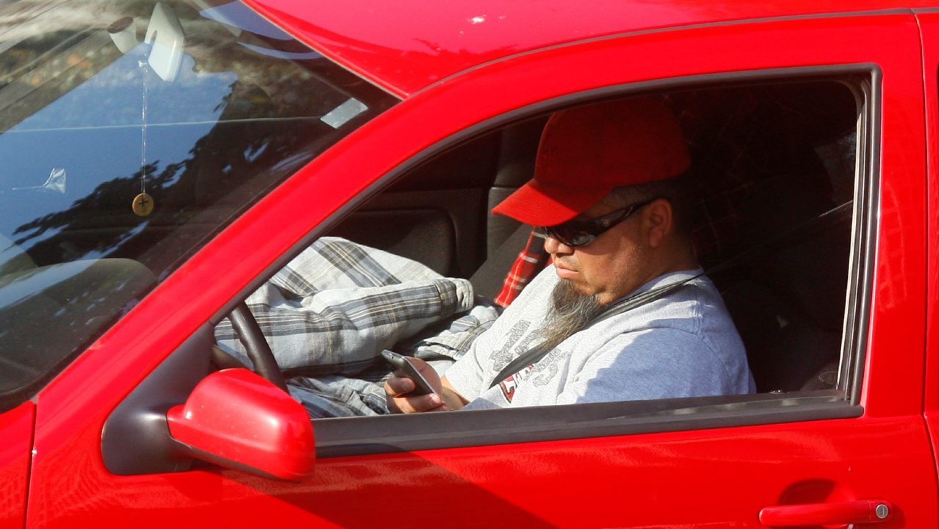 man texting car