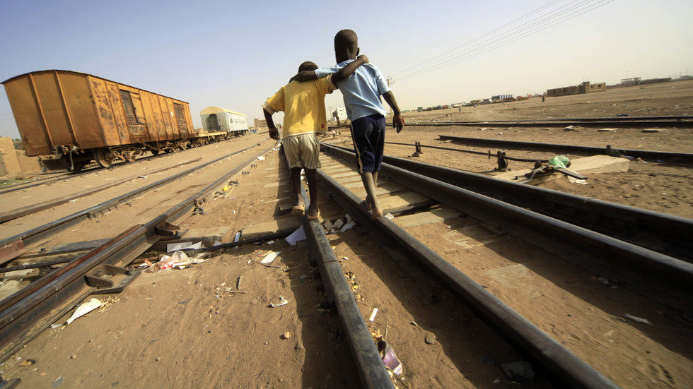 South Sudanese children wait at a train station in Khartoum