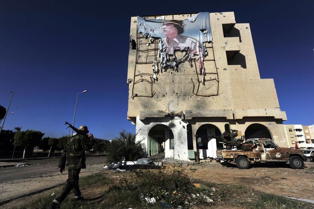 Click to enlarge torn gadaffi