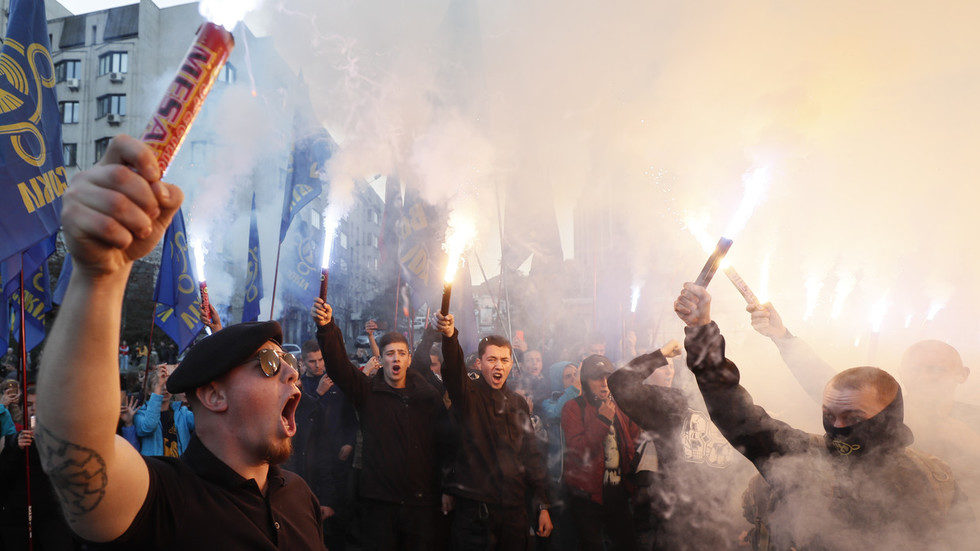 Ukrainian nationalists light flares during a procession in Kiev