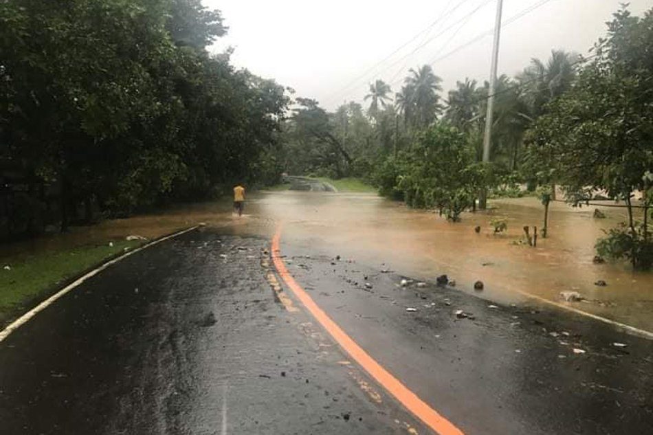 Click to enlarge A flooded portion of the highway in Labo town, Camarines Norte