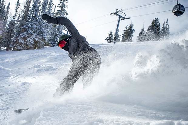 Chicago resident Cooper Bluhm, 18, slashes through some powder on Bell on Aspen Mountain on Friday morning.
