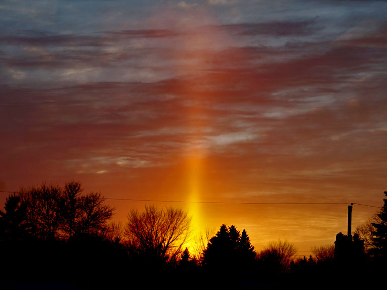 Sun pillar over Manitoba, Canada