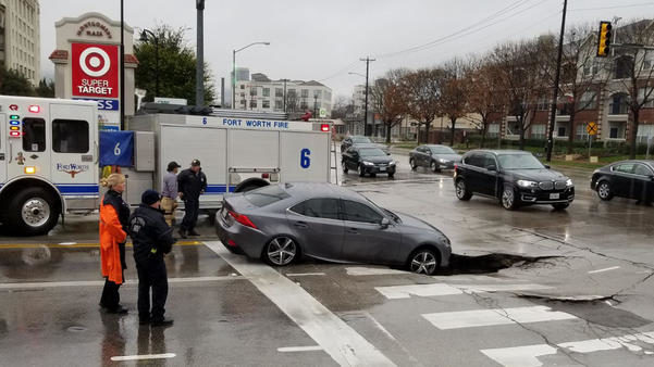 The driver of a Lexus sedan ended up in a sinkhole that opened up in Fort Worth, Jan. 3, 2019.