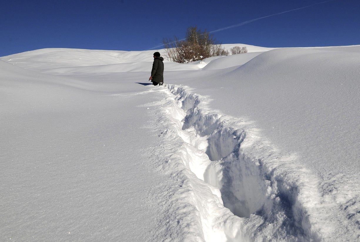 A villager walks through deep snow in Disbudak