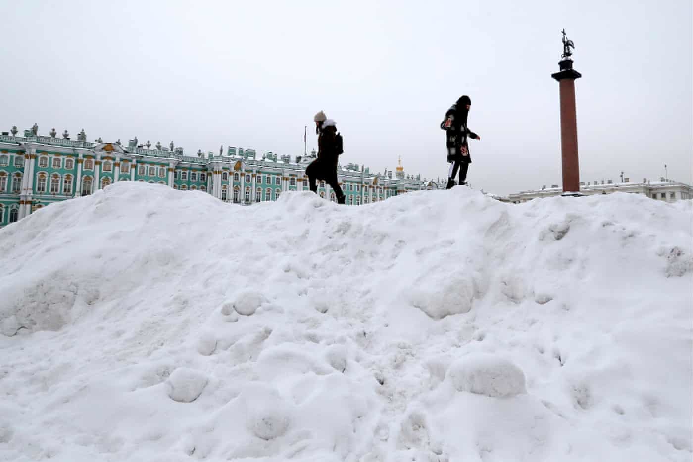 Girls climb piles of snow in Dvortsovaya (Palace) Square near the Winter Palace after a heavy snowfall in St Petersburg, Russia