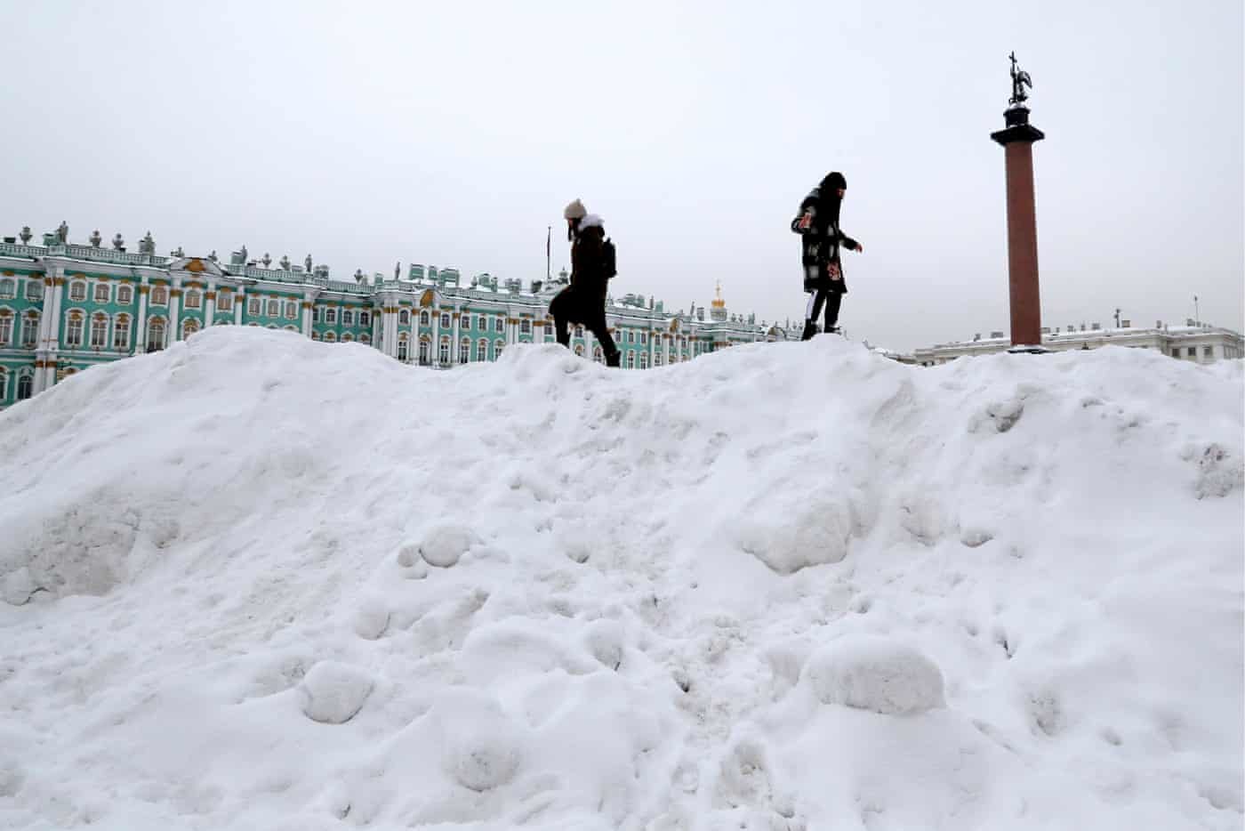 Click to enlarge Girls climb piles of snow in Dvortsovaya (Palace) Square near the Winter Palace after a heavy snowfall in St Petersburg, Russia