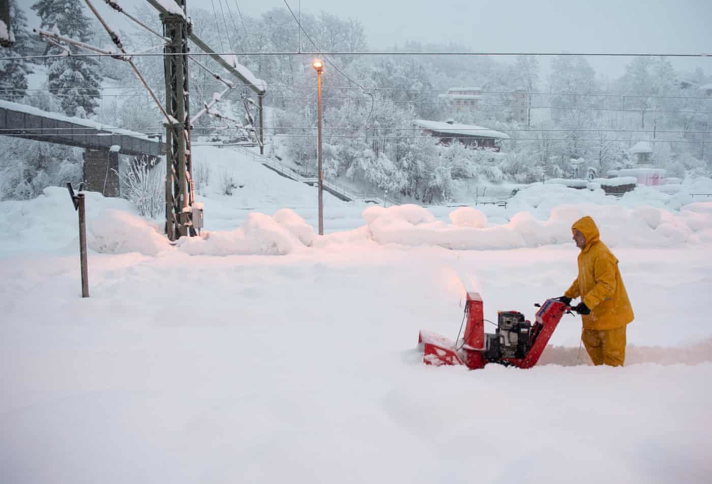 A man uses a snow blower to free a platform at the station in Berchtesgaden, Bavaria, Germany. Austria