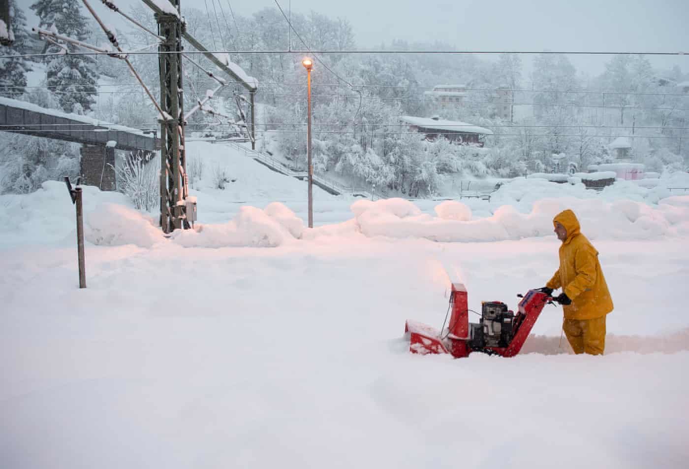 Click to enlarge A man uses a snow blower to free a platform at the station in Berchtesgaden, Bavaria, Germany. Austria
