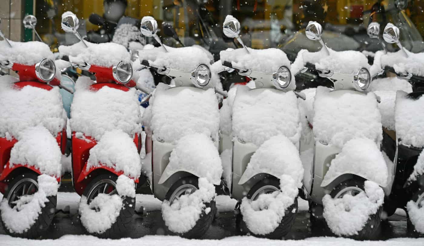 Click to enlarge Vespas covered with snow on a street in Zurich, Switzerland