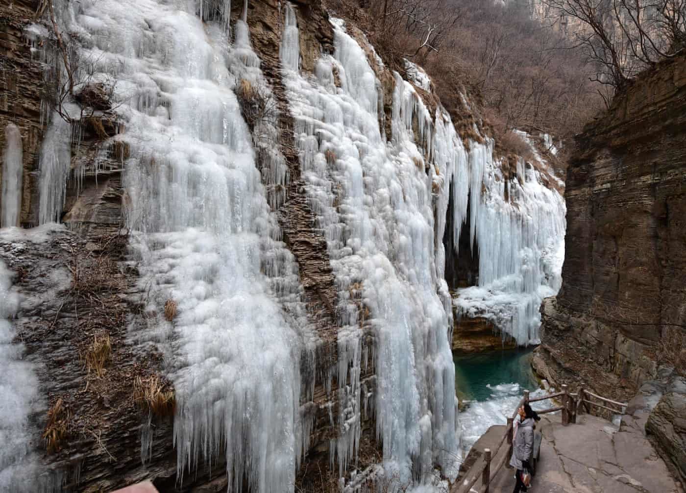 A tourist enjoying the scenery of icefall at Yuntai Mountain scenic spot in Jiaozuo, central China’s Henan Province