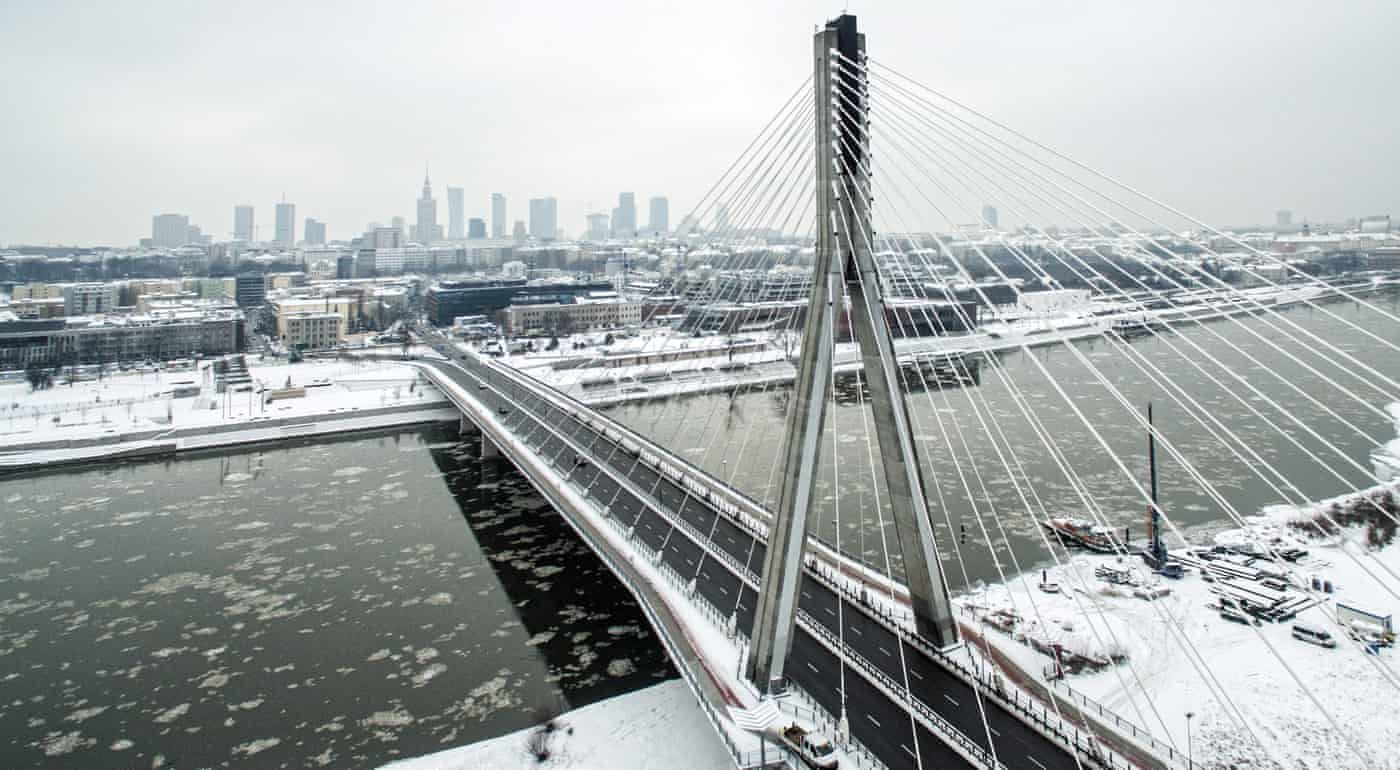 Aerial picture taken by a drone shows a snowy panorama of Warsaw and the Vistula River with Swietokrzyski Bridge in Poland