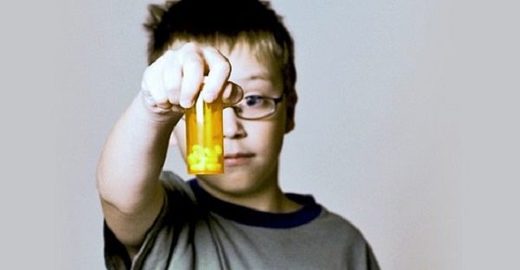 Boy holding meds